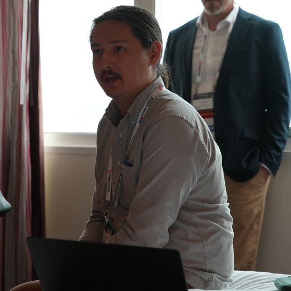 Taro Woollett-Chiba speaking at a conference